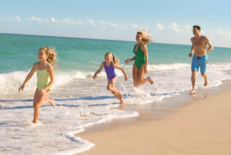 Happy Family Playing On the Beach | Bluegreen Vacations